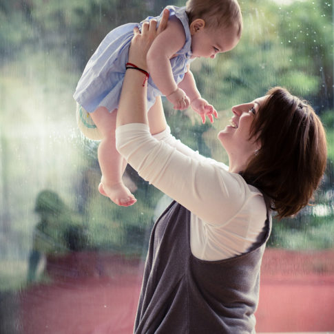 mom lifting baby