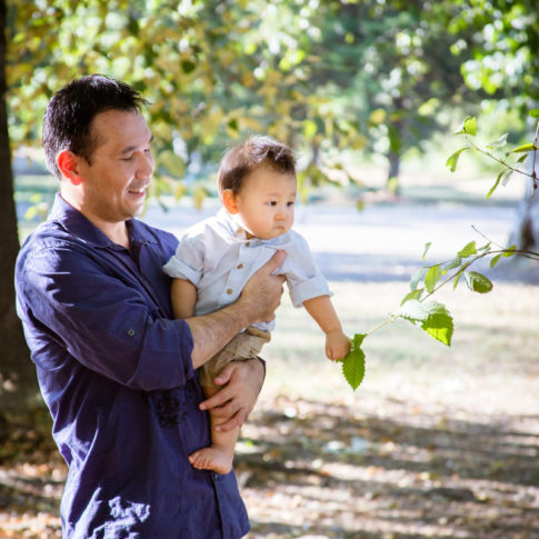 baby playing with leaves